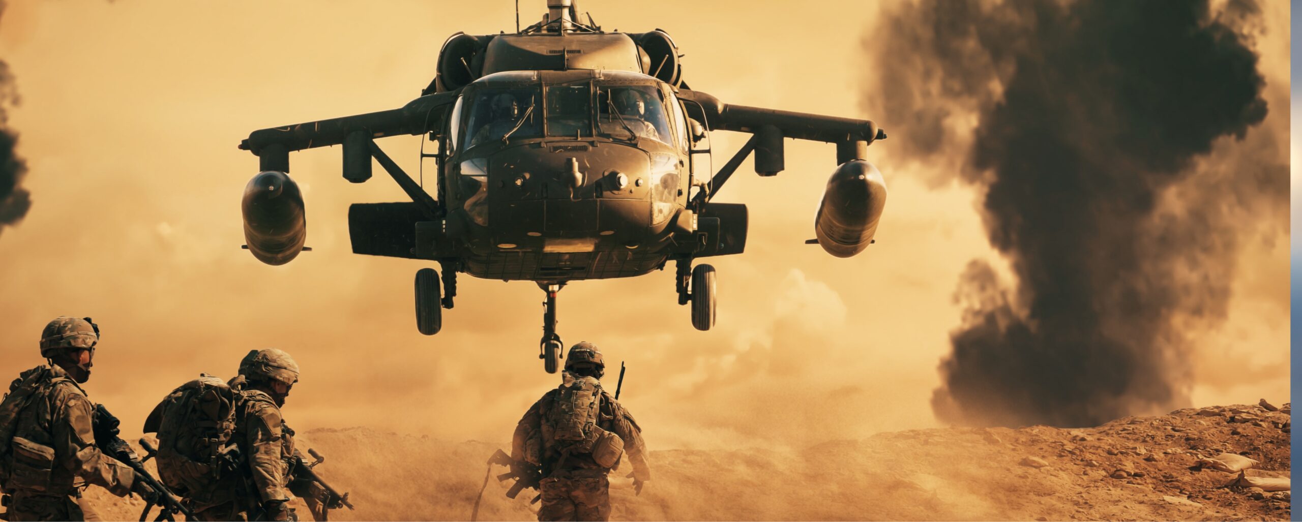 Military helicopter flying low above soldiers advancing across a dusty, orange-tinted battlefield with smoke rising in the background.